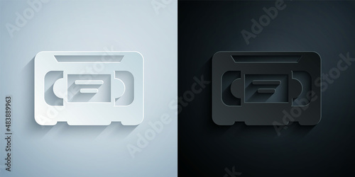 Paper cut VHS video cassette tape icon isolated on grey and black background. Paper art style. Vector