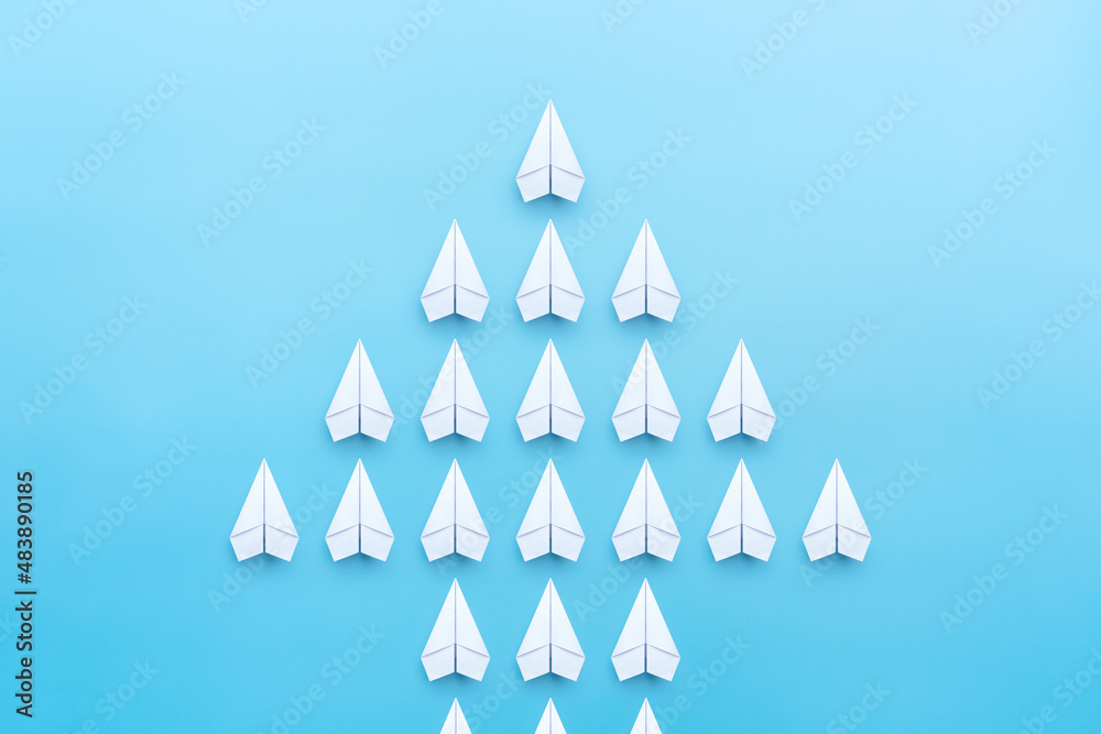 Paper plane group flying is an arrow symbol on blue background, Organization, Teamwork, Development, Growth.
