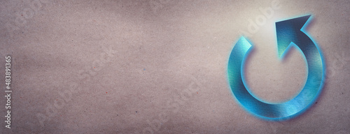 Foto Blue neon reload arrow icon on a craft textured paper background with copy space for your text