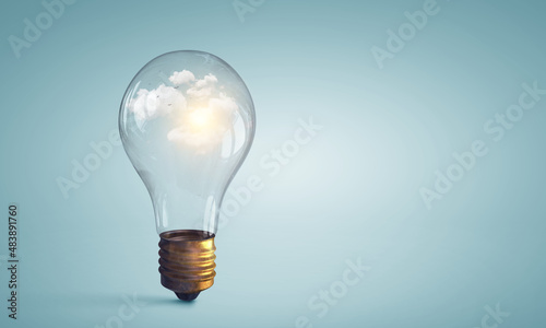 Light bulb on light blue background