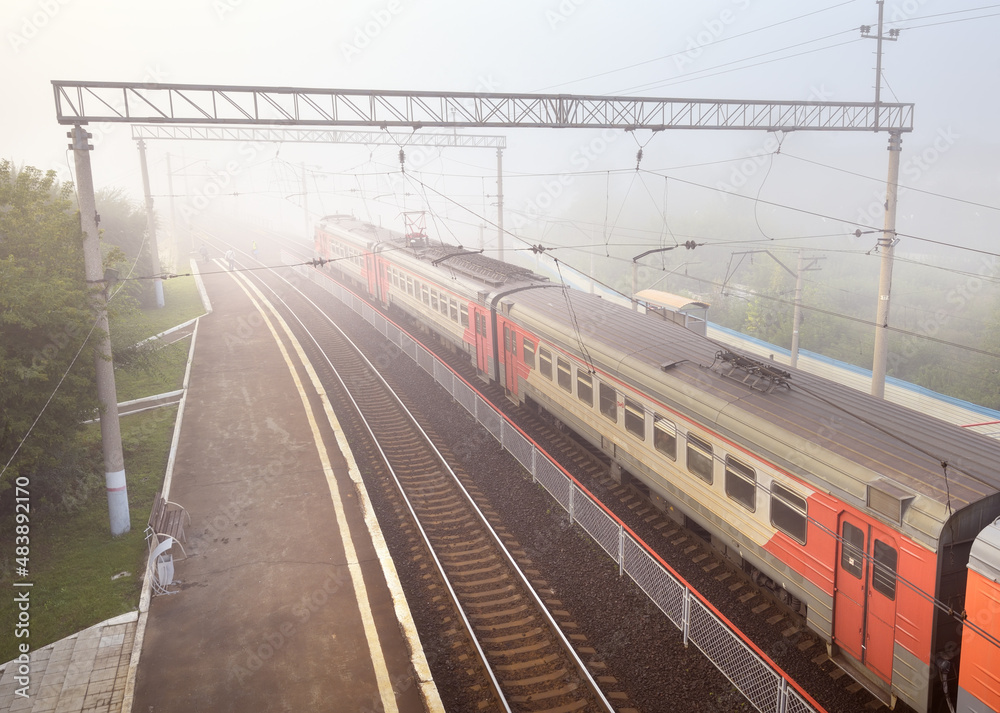 Novosibirsk, Siberia, Russia-08.15.2021: Train trains at the Pravaya Ob station in the fog Novosibirsk, Siberia, Russia-08.15.2021: Train trains at the Pravaya Ob station in the fog