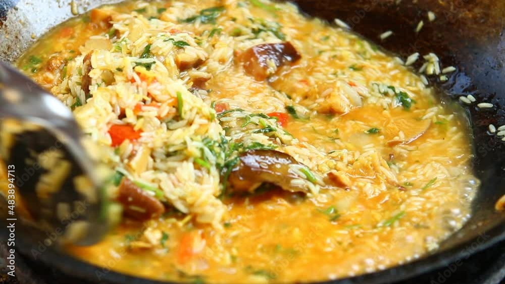 Man is cooking Indian Biryani in pan , in door Chiangmai Thailand. Man is cooking Indian Biryani in pan , in door Chiangmai Thailand.
