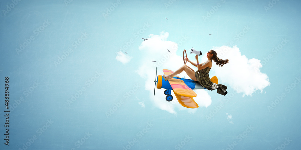 Fototapeta premium Woman flying on top of the plane