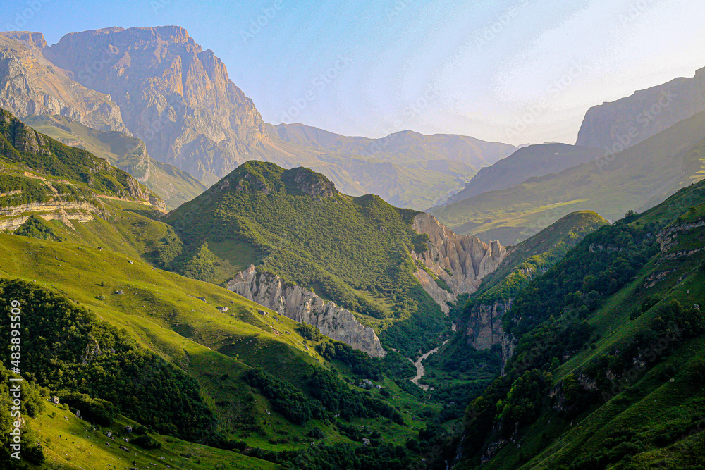 Fototapeta premium Traveler hiking in mountains clouds landscape