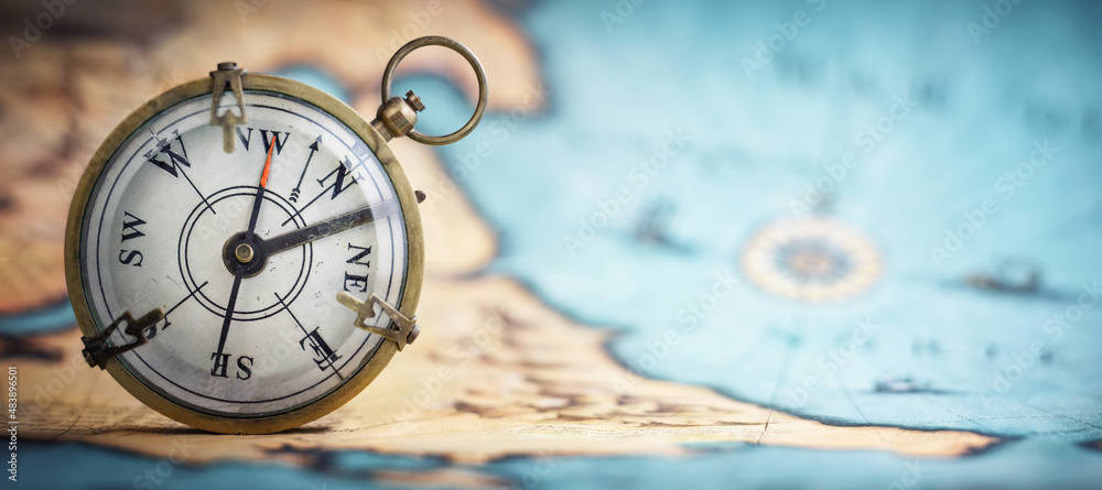 Magnetic old compass on world map.Travel, geography, navigation, tourism and exploration concept background. Macro photo. Very shallow focus. Magnetic old compass on world map.Travel, geography, navigation, tourism and exploration concept background. Macro photo. Very shallow focus.