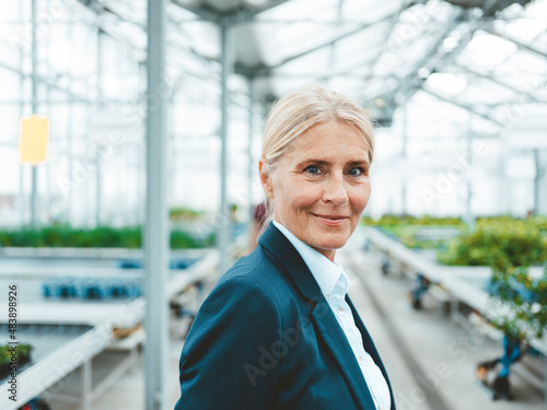 Smiling agronomist in garden center
