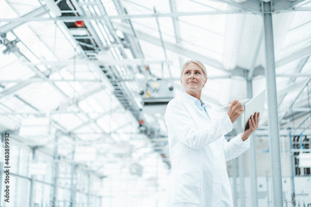 Thoughtful scientist in white lab coat at laboratory Thoughtful scientist in white lab coat at laboratory