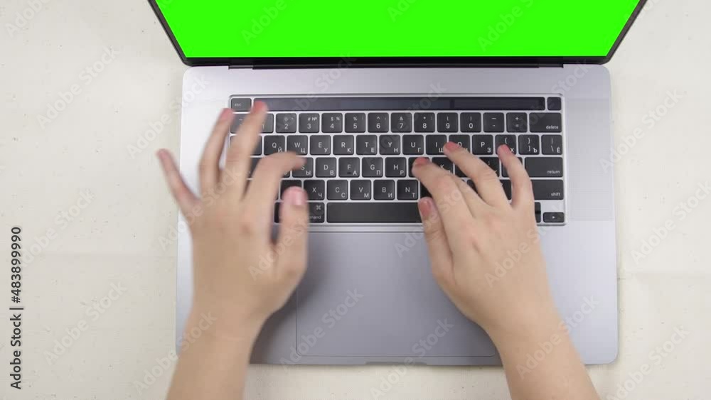 female hands typing on laptop top view female hands typing on laptop top view