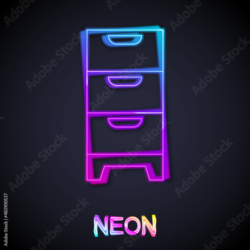 Glowing neon line Chest of drawers icon isolated on black background. Vector