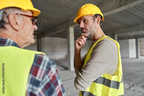 Back view of two caucasian engineers discussing on construction site