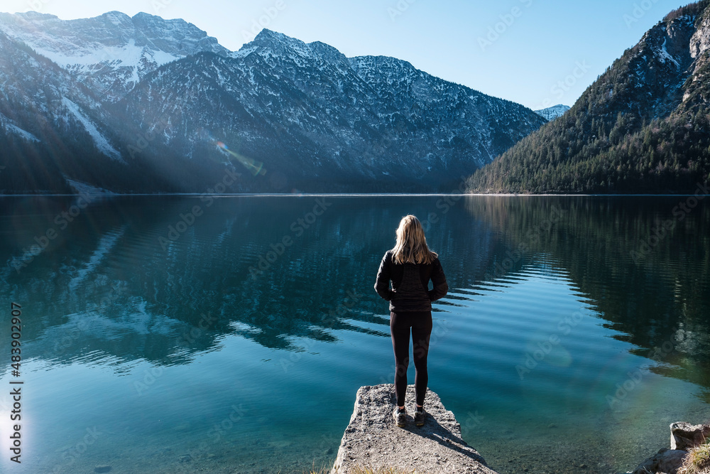 Woman looking across Lake Plansee to Ammergau Alps, Reutte, Tyrol, Austria Woman looking across Lake Plansee to Ammergau Alps, Reutte, Tyrol, Austria