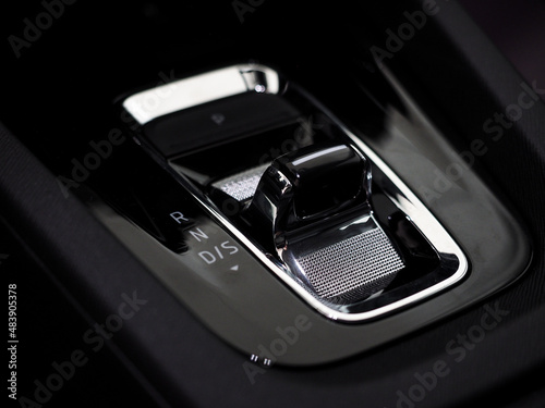 modern automatic gearbox gear selector. stylish car interior dark with chrome