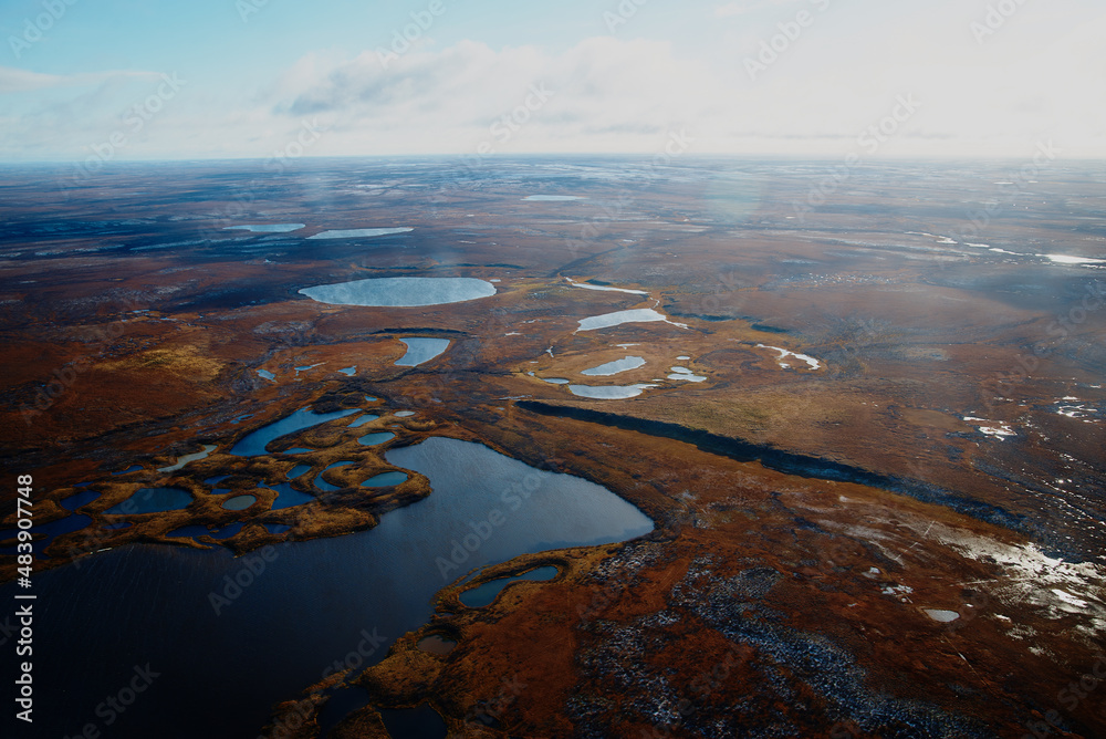 Aerial view and top view of the Lake in the tundra on the Taimyr Peninsula in Russia. Beautiful natural background. Blurred image, selective focus Aerial view and top view of the Lake in the tundra on the Taimyr Peninsula in Russia. Beautiful natural background. Blurred image, selective focus