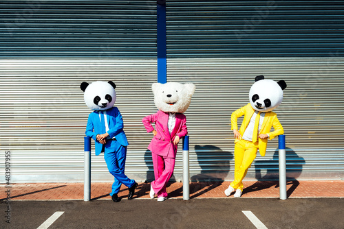 Fotomurale Storytelling image of a group of friends wearing giant panda head