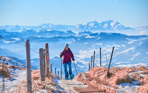 nice senior woman snowshoei...