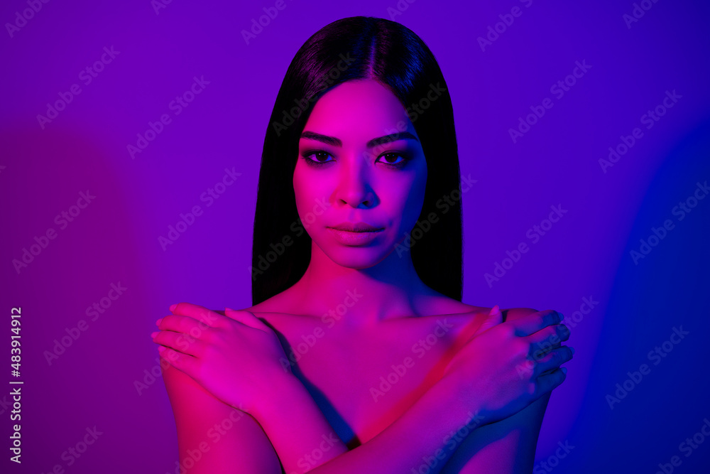 Photo of charming girlish lady touch hands shoulders silky shower wash isolated vivid ultraviolet color background Photo of charming girlish lady touch hands shoulders silky shower wash isolated vivid ultraviolet color background