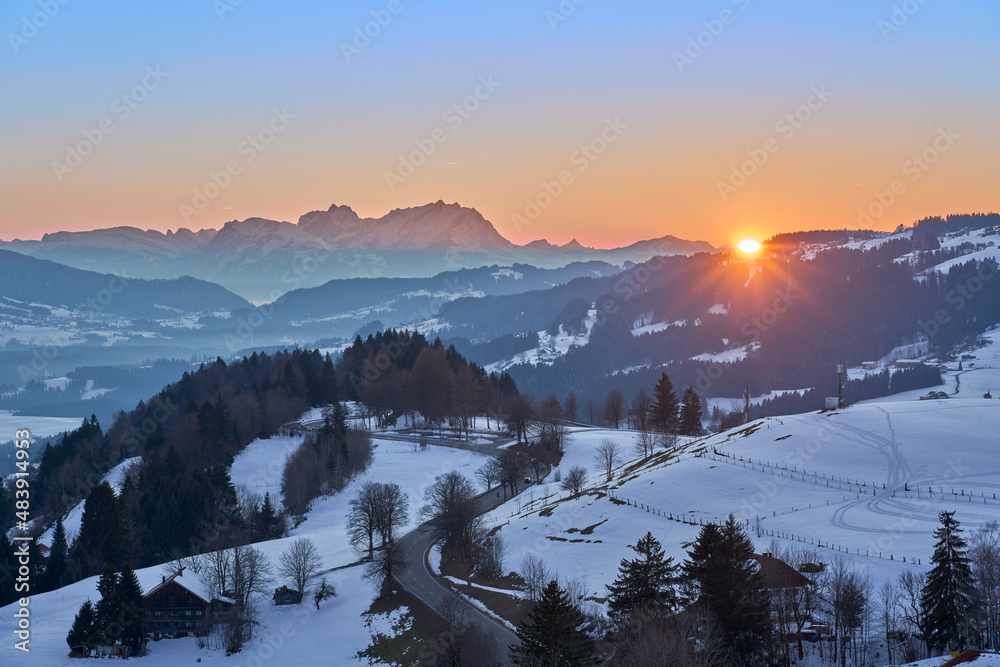 cold winter landscape  in evening light at sunset, with Mount Saentis, Switzerland in background in the Allgaeu Alps near Oberstaufen, Bavaria, Germany