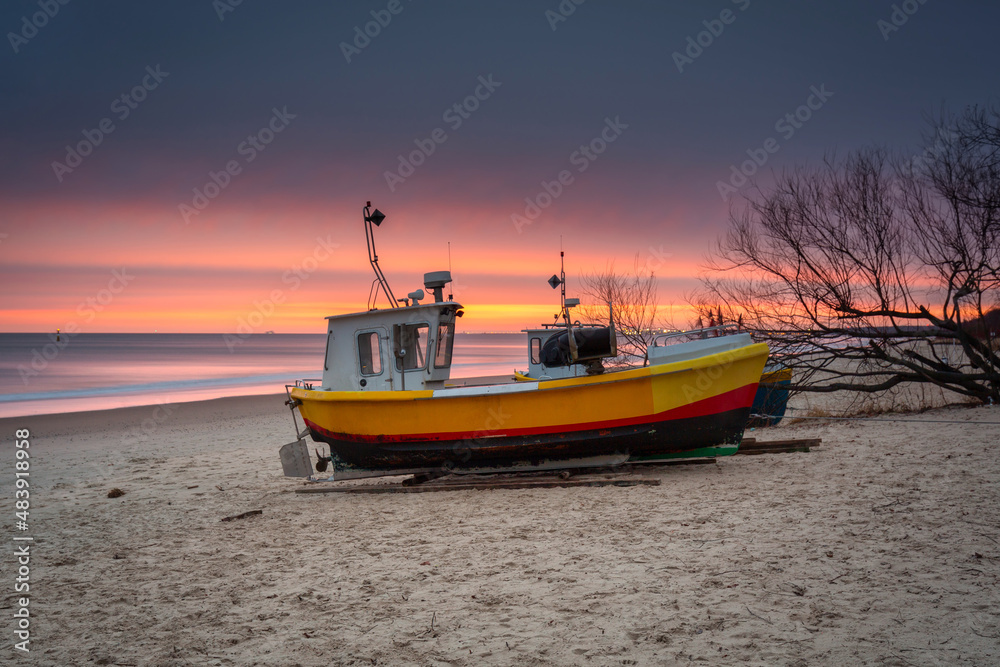 Fishing boats at sunrise on the Baltic Sea beach in Sopot. Poland Fishing boats at sunrise on the Baltic Sea beach in Sopot. Poland