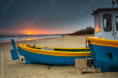Fishing boats at sunrise on the Baltic Sea beach in Sopot. Poland