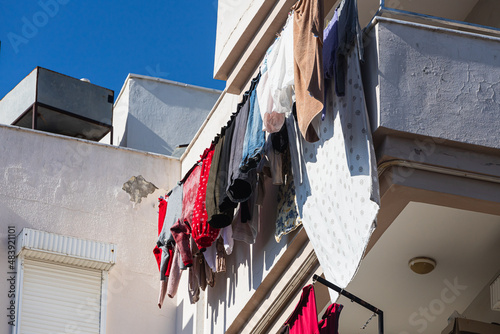 A white house in an turkish  city, laundry is drying on a rope photo