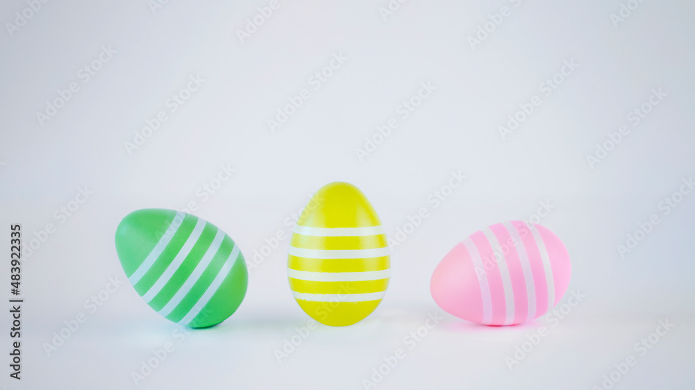 Green, yellow and pink easter eggs on white background. Easter image with copy space Green, yellow and pink easter eggs on white background. Easter image with copy space