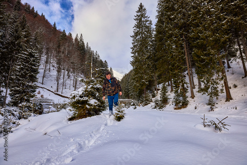 a tourist in winter landscape in the mountains