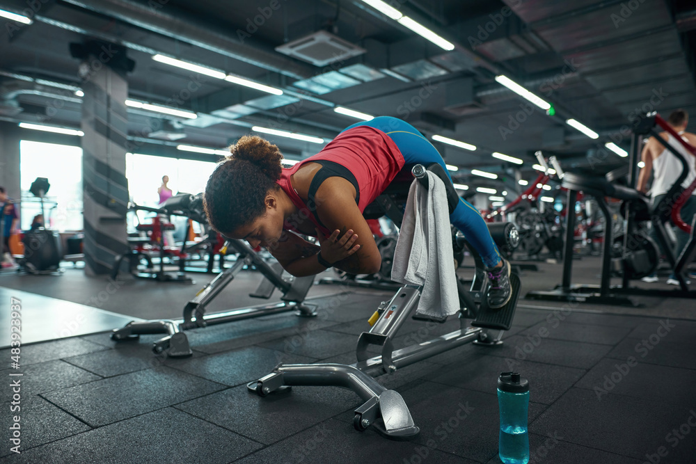 Girl do exercise for lumbar on training apparatus