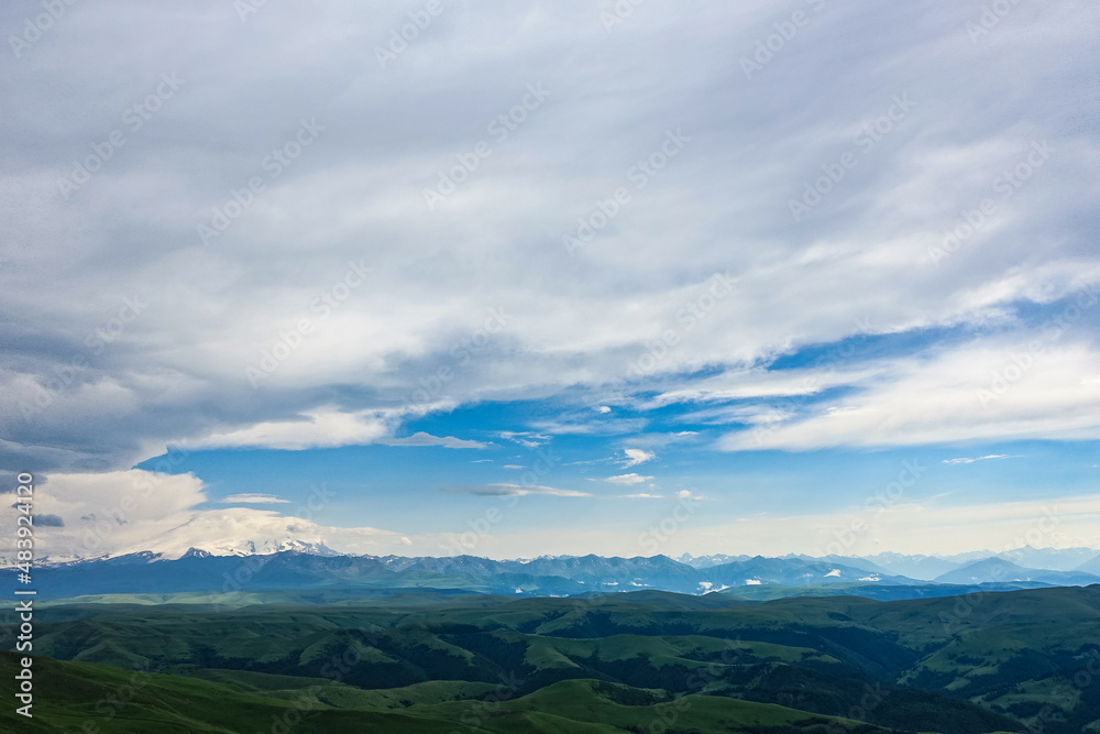 View of Elbrus and the Bermamyt plateau in the Karachay-Cherkess Republic, Russia. The Caucasus Mountains. View of Elbrus and the Bermamyt plateau in the Karachay-Cherkess Republic, Russia. The Caucasus Mountains.