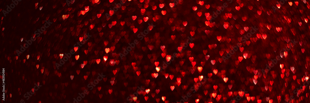 Red hearts, sparkling glitter bokeh background texture. Holiday valentines day lights. Abstract defocused header. Wide screen wallpaper. Panoramic web banner with copy space for design