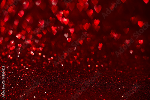 Red hearts, sparkling glitter bokeh background, valentines day abstract defocused texture