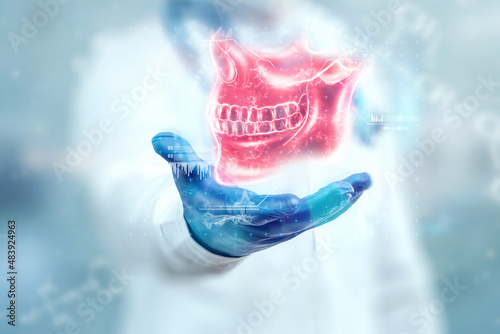 Medical poster, human skull anatomy, jaw x-ray, teeth snapshot. The doctor looks at the x-ray hologram of the jaw. Dentist, orthodontist, toothache, bite. photo