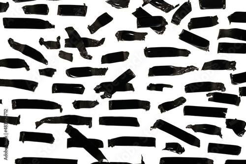 Torn black sticky tape of different sizes isolated on a white background