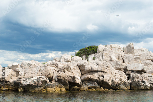 Small isolated rocky islet with seagulls in Adriatic sea, Croatia, Zadar region