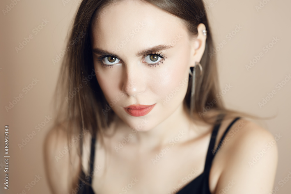 Fototapeta premium Portrait of a beautiful young woman with brown eyes.