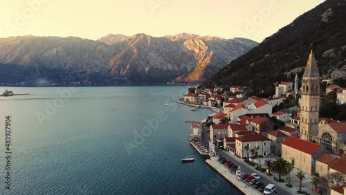 Panoramic sunset aerial drone view of the ancient city of Perast, Montenegro.Old medieval town with red roofs and with majestic mountains on background.Picturesque Kotor bay, coast of Adriatic sea. photo