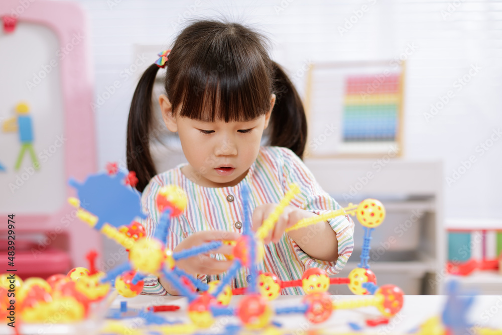 young girl playing creative 3d shape toy for homeschooling young girl playing creative 3d shape toy for homeschooling