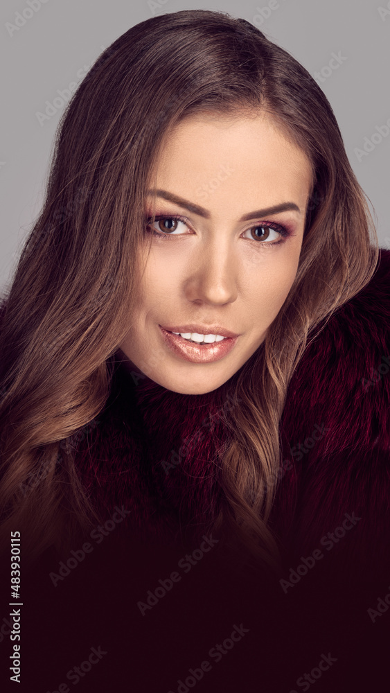 Young gorgeous woman with long curly brunette hair posing in fur coat Young gorgeous woman with long curly brunette hair posing in fur coat