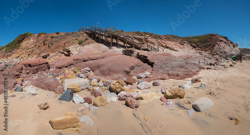 rocky algarve coast with colorful sandstones, boardwalk to the beach photo