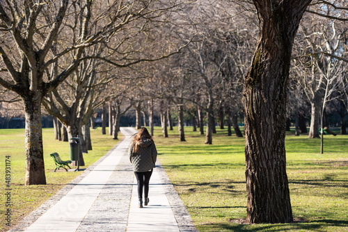 Fototapeta Naklejka Na Ścianę i Meble -  Lonely woman walks in the park