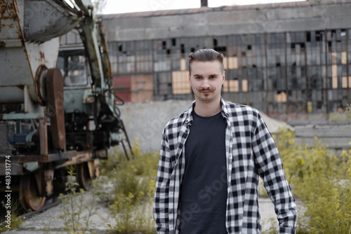 Portrait of handsome man with mustache in checkered black and white shirt. Close-up.