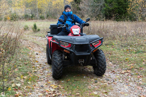 Rescuer Inspecting Woods Area by Atv Quad Bike