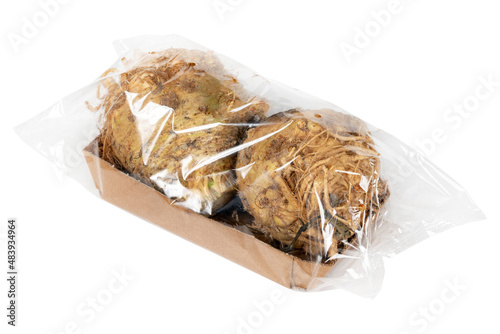 Packaged and labeled root celery on an isolated white background photo