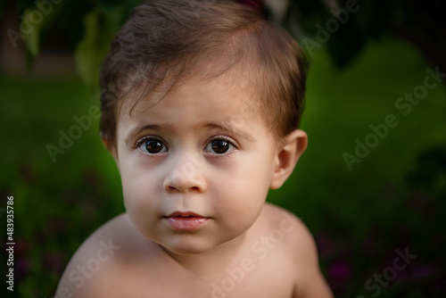 Baby boy's portrait on green background