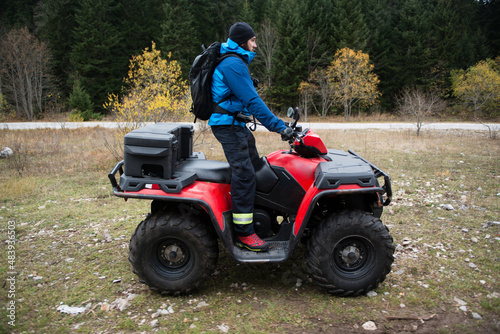 Rescuer Doing Lookout in Woods on a Quad