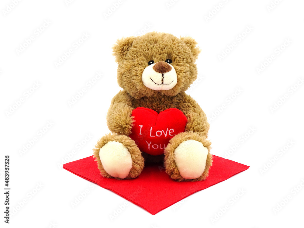 Brown teddy bear holding red heart with text 'I love you', isolated on white background. Brown teddy bear holding red heart with text 'I love you', isolated on white background.