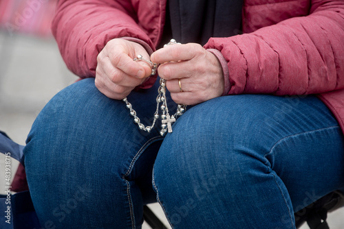Hands holding a rosary at the Sanctuary of Our Lady of Fatima, Portugal