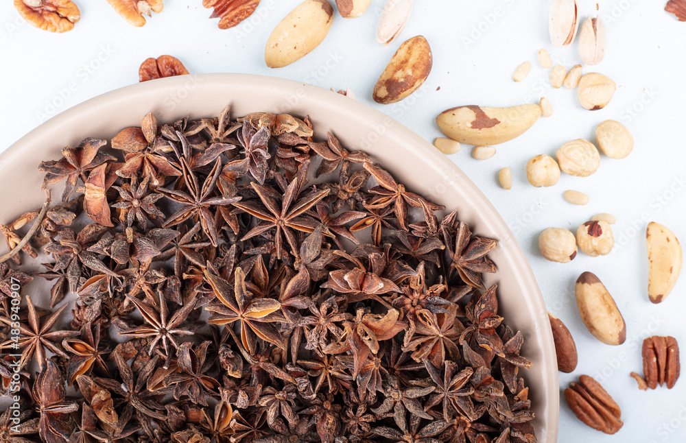 Star anise seasoning in a plate on a light tablecloth