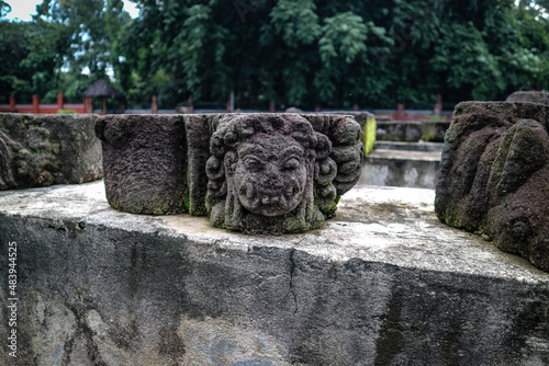 Stone head statue in the courtyard of the ancient Surowono temple, Pare, Kediri, Indonesia photo