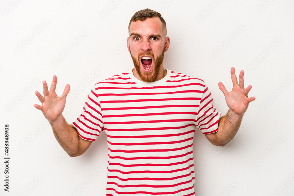 Young caucasian man isolated on white background screaming to the sky, looking up, frustrated.