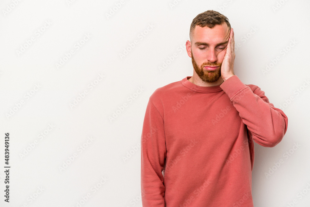 Fototapeta premium Young caucasian man isolated on white background who feels sad and pensive, looking at copy space.